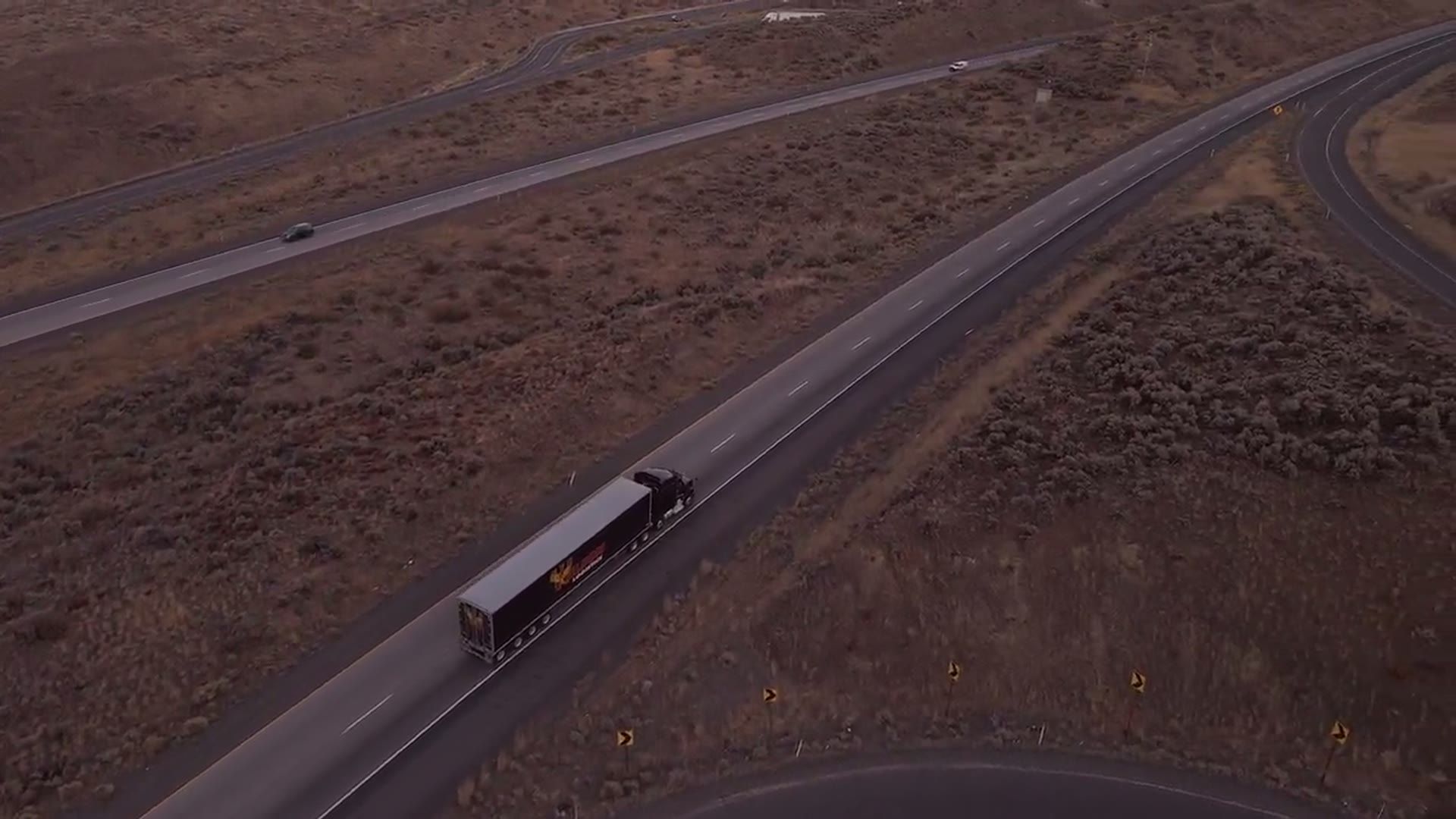 A semi truck climbing a long mountain grade under load