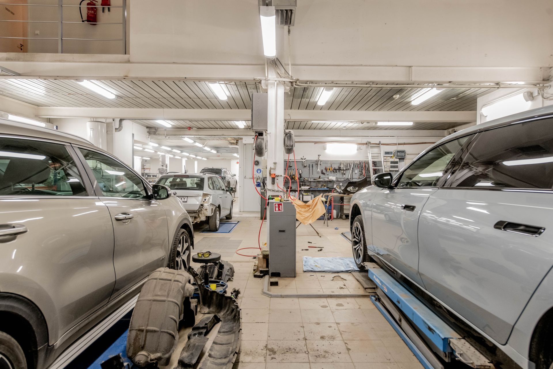 Cars raised on lifts inside an automotive workshop