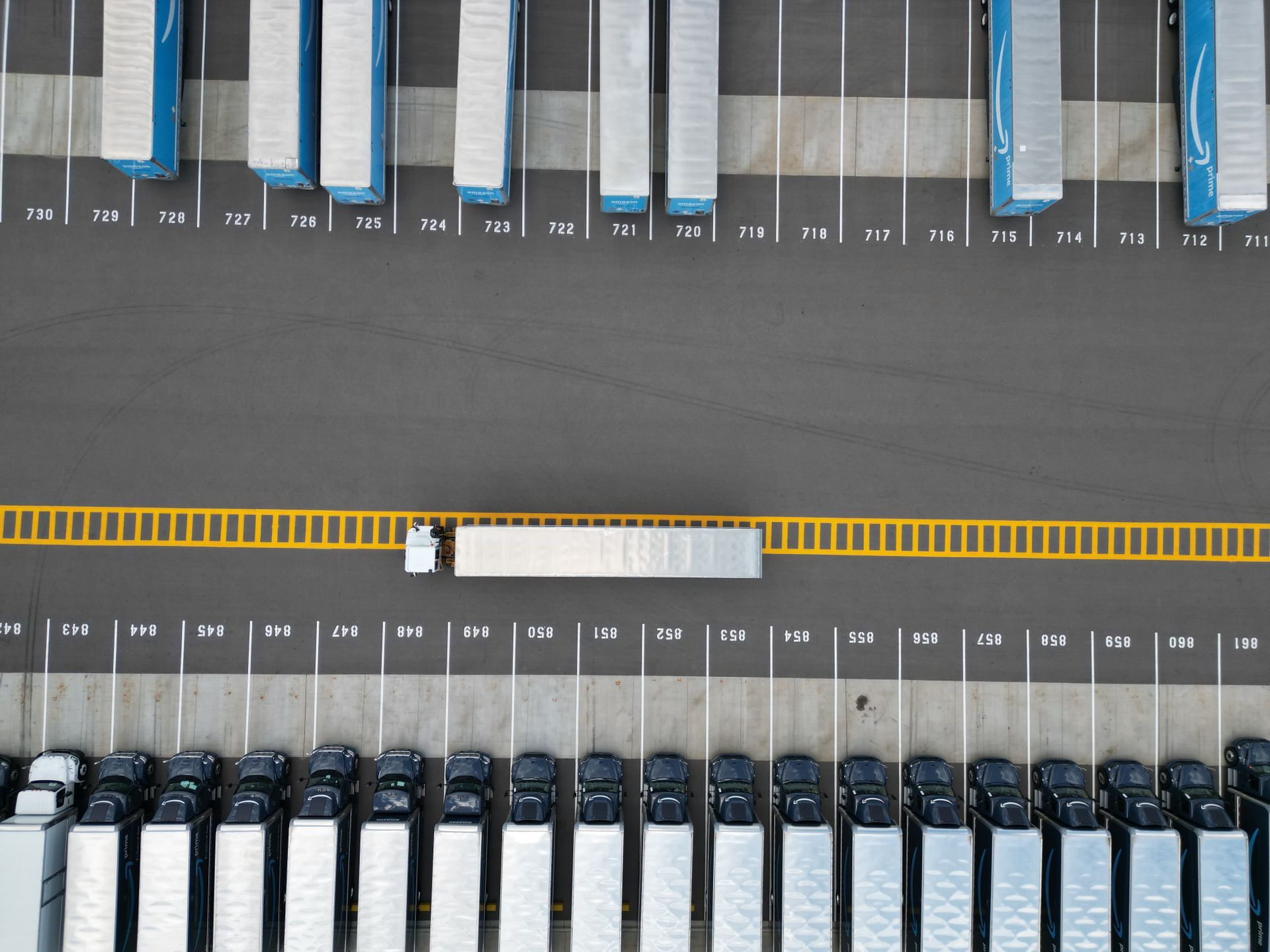 An aerial view of trailers parked in marked spaces in a large yard